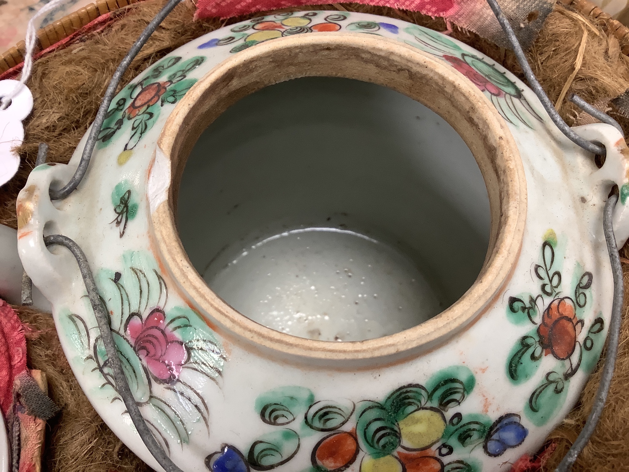 A Chinese teapot and two tea bowls, in carrying basket